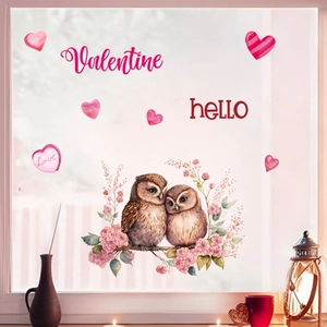 Detail view of Valentine's Day owl static window stickers on a glass surface