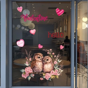 Detail of Valentine owl window clings with love hearts and text on a glass door