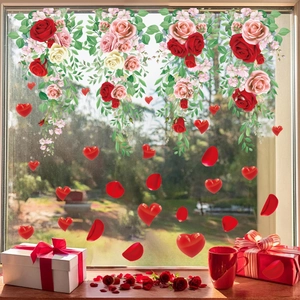 Detail of hanging rose vine window clings with red hearts for festive glass decoration