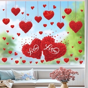 Detail of red Valentine's Day heart window clings with Love text on a glass surface