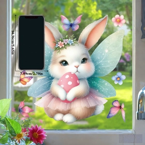Detailed view of an Easter bunny window sticker with fairy wings next to a phone for scale