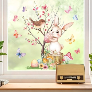 Close-up of watercolor Easter bunny and birds electrostatic window stickers on bright glass