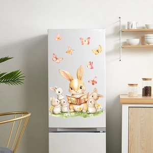 Watercolor bunny family window stickers on a white fridge in a cozy kitchen setting
