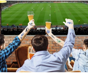 Supporters wearing waterproof soccer themed temporary tattoos for football match events