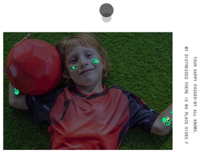 Luminous football temporary tattoos glowing on a young fan boy on green grass field