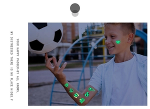 Luminous soccer tattoos for kids showing green glowing football patterns on a child's arm