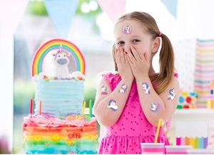 Surprised girl with cute cartoon unicorn temporary tattoos in a colorful party scene