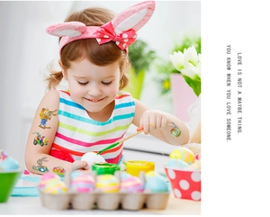 Close-up of Easter temporary tattoos with rabbit and egg patterns on a child's arm