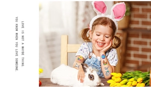 Detail of colorful Easter bunny and egg temporary tattoos on a child's arm during a party