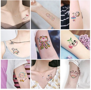 Macro detail of colorful cartoon temporary tattoos with cute animals and rainbow patterns