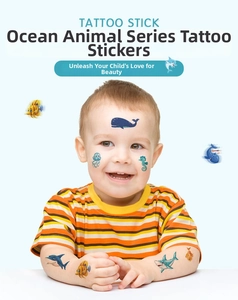 Close-up of ocean animal temporary tattoos on children skin including whale and shark