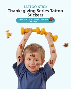 Kids Thanksgiving temporary tattoos showing turkey and pumpkin patterns on a boy's skin