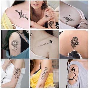 Detail of waterproof temporary tattoos with floral and animal designs on skin