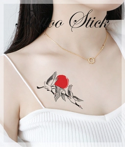 Detail of artistic crane and sun temporary tattoo sticker on model's collarbone