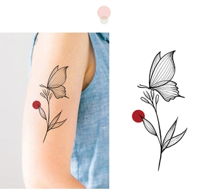 Detail of waterproof butterfly and leaf temporary tattoo sticker on skin and white background