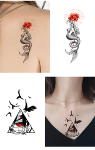 Detail of waterproof temporary tattoo showing red eye and mermaid designs on skin