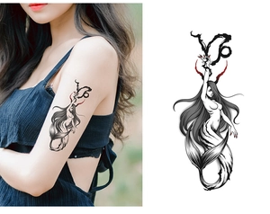 Detail of dark mermaid tattoo sticker with artistic black calligraphy and red accents