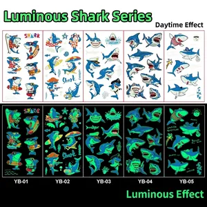 Glow-in-the-dark cartoon shark temporary tattoos showing day and night luminous effects