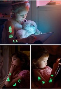 Luminous temporary tattoos showing glowing green unicorn and magic patterns on kids' skin