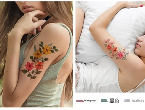 Détails de tatouages temporaires de fleurs imperméables en orange et rose sur le bras