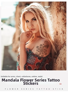 Detailed view of a black mandala flower temporary tattoo on a model shoulder