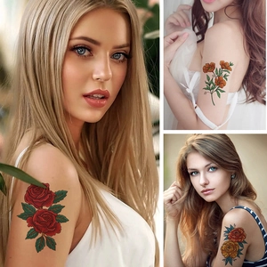 Colorful floral temporary tattoos featuring red rose and orange flowers on woman's arm