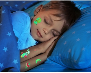 Glow-in-the-dark space tattoos for kids showing glowing rockets and aliens at night