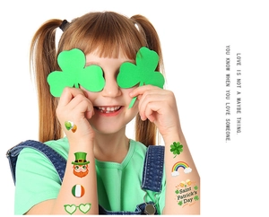 Saint Patrick's Day clover and rainbow temporary tattoo stickers on child's arm