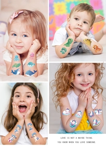 Close-up of children's waterproof temporary tattoos with ocean and dinosaur designs