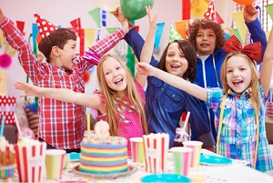 Vibrant birthday party scene with rainbow cake, colorful party hats and festive balloons