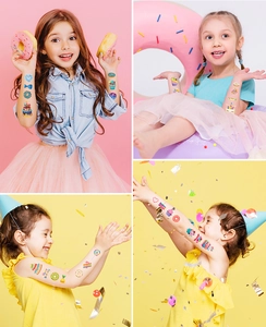 Kids temporary tattoos showing colorful donuts and rainbow designs on children arms