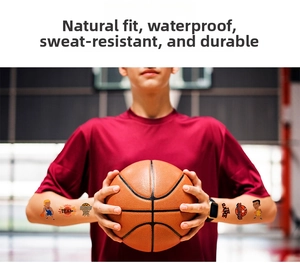 Detail of waterproof cartoon basketball temporary tattoos on arms for sports fans