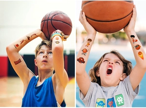 Detail of basketball themed temporary tattoos on boy's arms with dunking silhouette