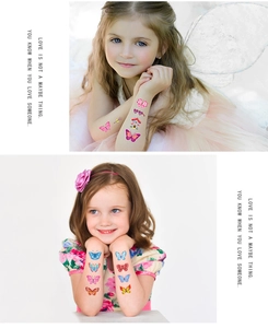 Détail de tatouages temporaires papillon et cœur colorés sur le bras d'un enfant