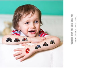 Close-up of vibrant cartoon monster truck temporary tattoos on a child's arm and hand