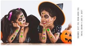 Kids wearing luminous Halloween temporary tattoos with pumpkin and bat designs for parties