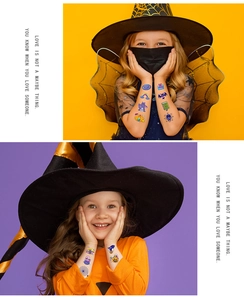 Children showing colorful Halloween temporary tattoos with pumpkins and bats on arms