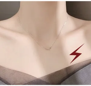Detail of silver double cross star pendant necklace worn by a female model