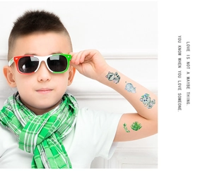 Detail of colorful waterproof glitter animal tattoos on child's arm for parties