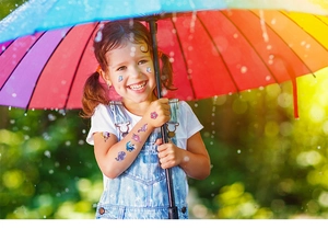 Close-up of waterproof glitter unicorn and butterfly temporary tattoos for kids outdoors