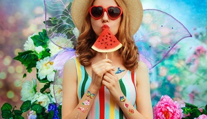 Girl wearing colorful butterfly and floral temporary tattoos for a summer pool party