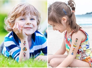 Detail of colorful waterproof glitter pirate tattoos on children during outdoor play