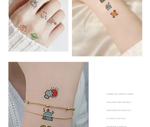 Detail of colorful cartoon temporary tattoo stickers applied on wrist and hand skin