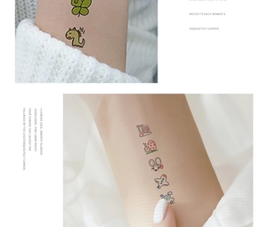 Detail of colorful cartoon temporary tattoos showing dinosaur and car designs on skin