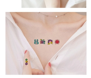 Close-up of cute waterproof temporary tattoos with cartoon rabbits and rainbow sun motifs