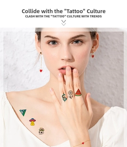 Detail of colorful temporary tattoos featuring creative snake and ufo designs on skin