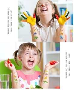 Detailed view of colorful laser gold dinosaur cartoon tattoos applied on children's arms