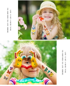 Gros plan de tatouages temporaires papillon colorés sur la peau d'enfants au parc