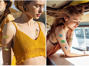 Detail of Hawaii temporary tattoos showing tropical toucan and palm leaf patterns on skin
