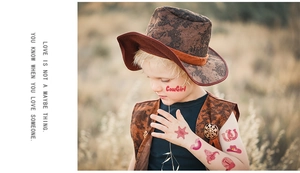 Detail of pink cowgirl tattoo stickers with horseshoe and star on a child's face